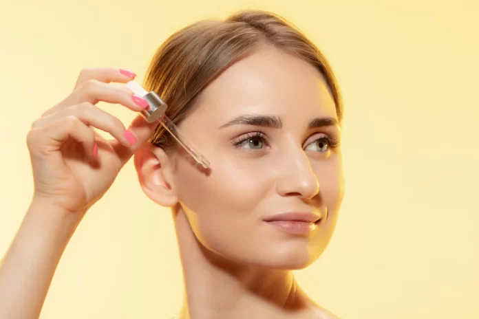 protection-close-up-beautiful-female-face-with-pouring-essential-oil_155003-42423
